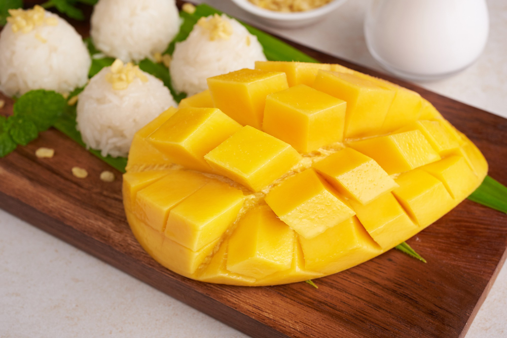 ripe-mango-sticky-rice-with-coconut-milk-wood-plate-stone-surface-tropical-fruit-dessert-fruit-thai-sweet-dessert-summer-season